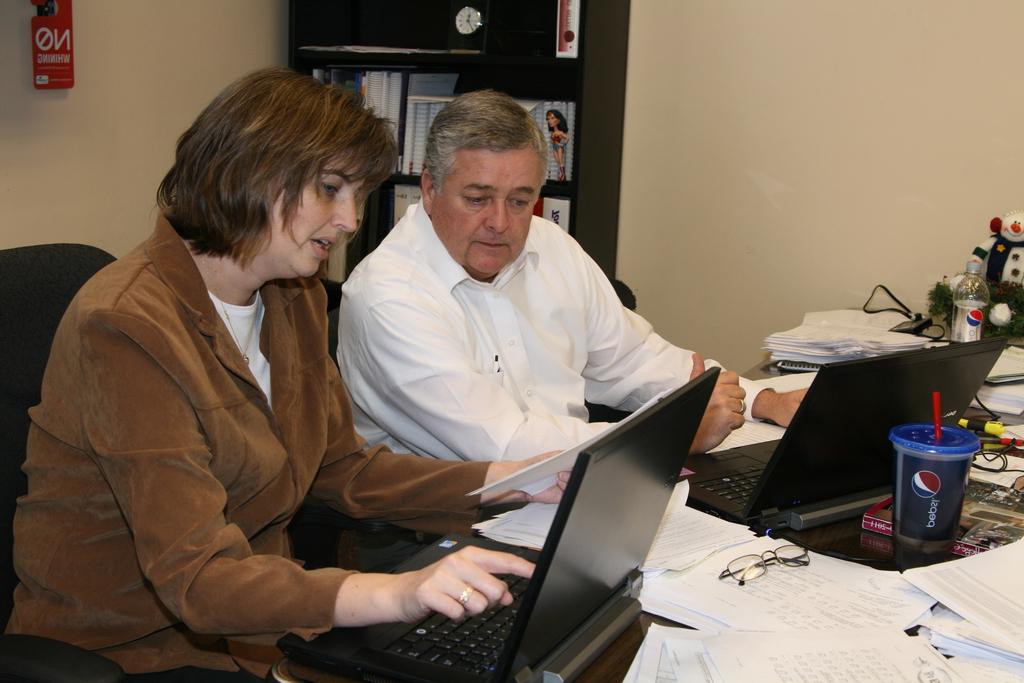 Dale Williamson and Joby Collins prepare for April's registration.