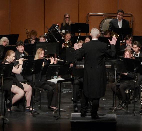 Band leader and musicians performing on stage